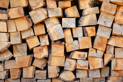 Pile of sawn wood logs ready for winter, close up.. Background of chopped firewood logs. wood texture.