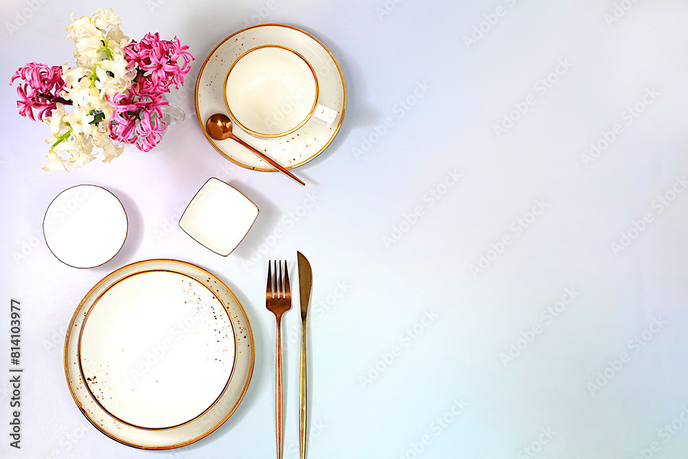 Elegant festive table setting. Cutlery with flowers on a plate on a marble background., menu layout in a cafe or restaurant, festive composition with a bouquet of hyacinths, kitchen background. Elegant festive table setting. Cutlery with flowers on a plate on a marble background., menu layout in a cafe or restaurant, festive composition with a bouquet of hyacinths, kitchen background.