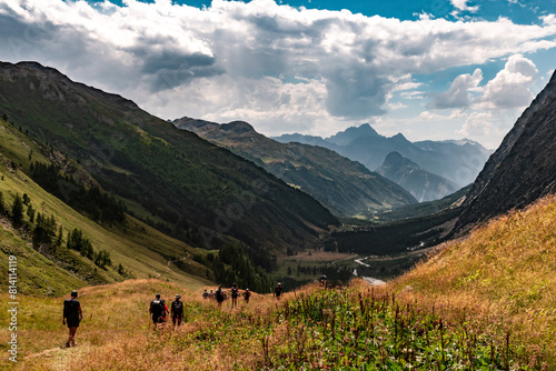 View of the valley to the West and hikers from the descent of the Grand Col Ferret