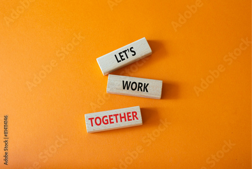 Lets work together symbol. Concept words Less is More on wooden blocks. Beautiful orange background. Business and Less is More concept. Copy space.