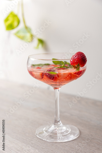 a cocktail with strawberries and basil