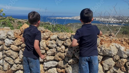 Two boys, brothers exploring the area near Selmun palace, Malta. High quality FullHD footage photo