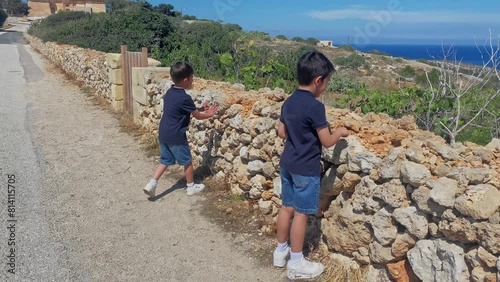 Two boys, brothers exploring the area near Selmun palace, Malta. High quality FullHD footage photo