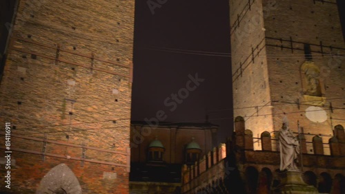 Two Towers are symbol of Bologna, Italy, and most prominent of Towers of Bologna. Taller one is called Asinelli while smaller but more leaning tower is called Garisenda. Statue of Saint Petronius. photo