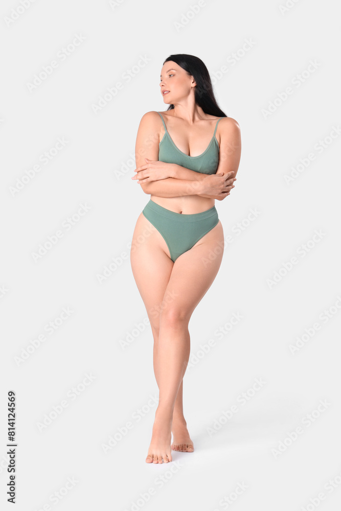 Young woman in underwear on light background Young woman in underwear on light background
