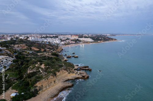Aerial Drone View of the Blue Ocean and Waves Crashing Along the Beach in Albufeira Portugal © suraju