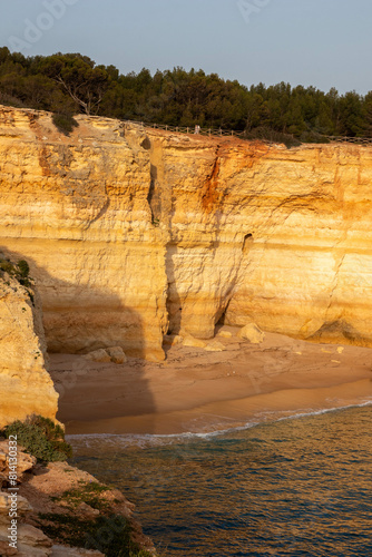 View Cliffs along the Beach at Sunset in Albufiera Portugal photo