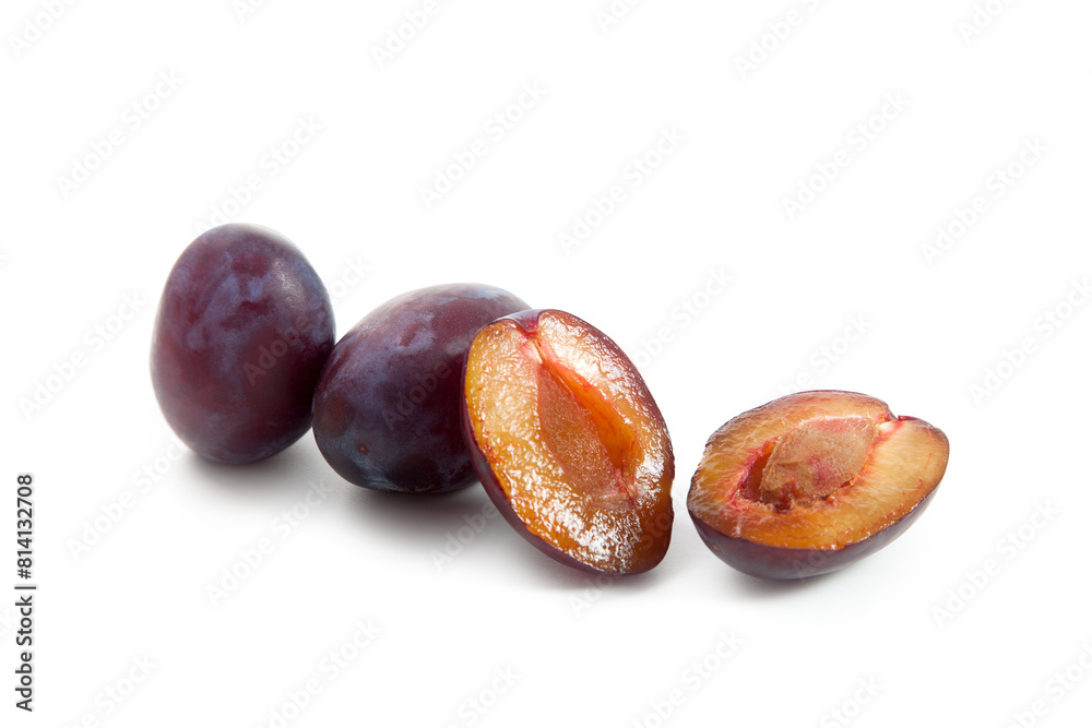 Two Whole and Halves purple plums isolated on white background. . Two Whole and Halves purple plums isolated on white background. .