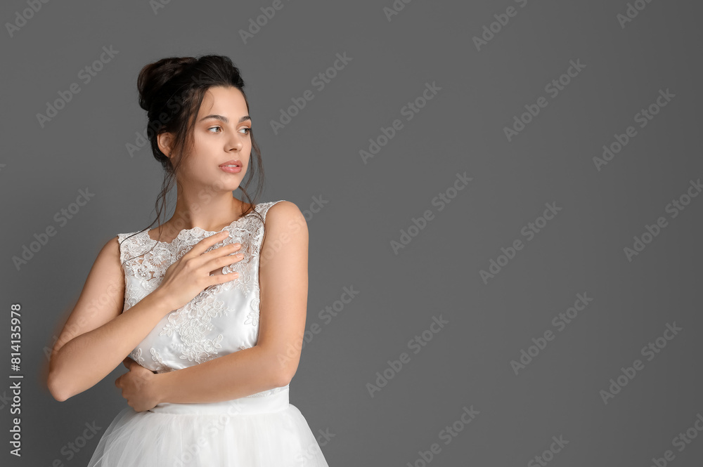 Young bride in wedding dress on dark background Young bride in wedding dress on dark background