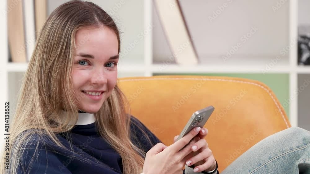 girl with mobile phone on the sofa chatting girl with mobile phone on the sofa chatting