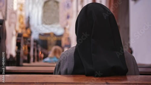 Catholic Nun Wearing Grey Religious Habit Tunic Saying Prayer During Holy Mass photo