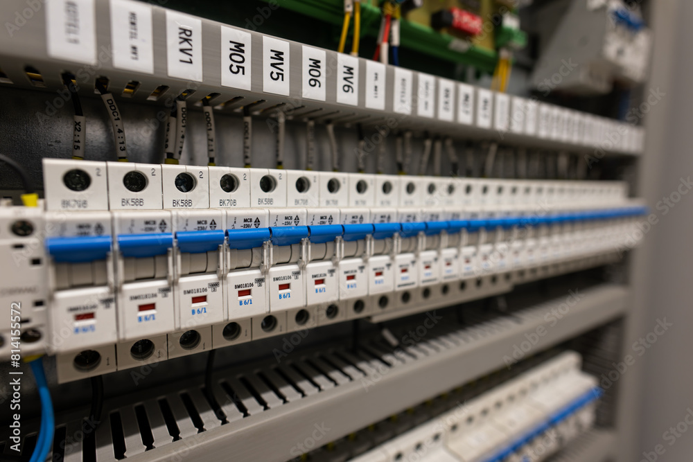 A row of circuit breakers in a switchboard next to each other.