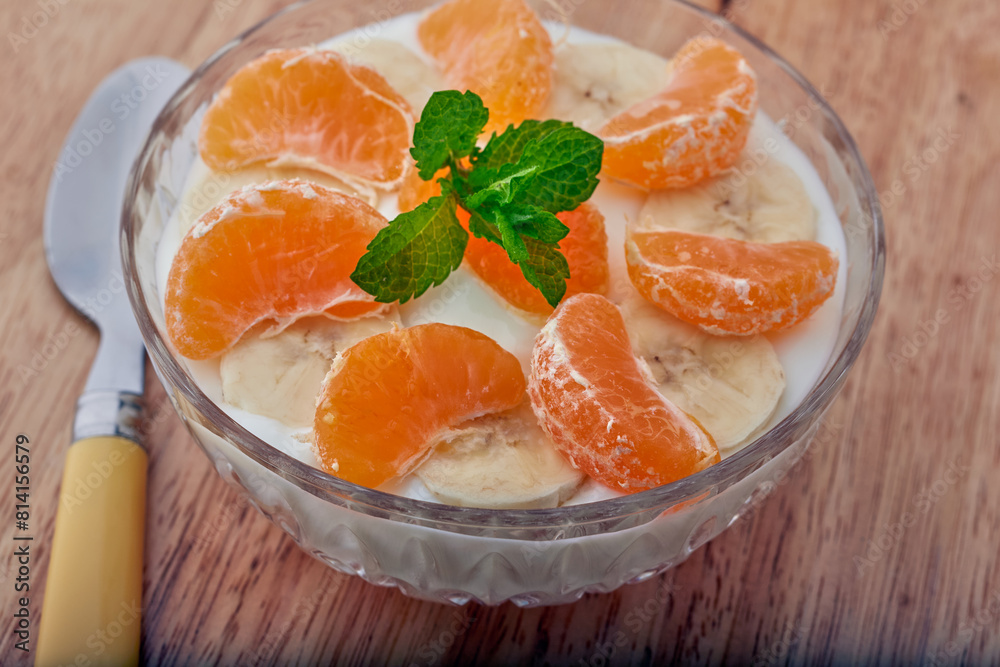 Bowl of fruit with Greek yogurt and garnished with mint. Bowl of fruit with Greek yogurt and garnished with mint.