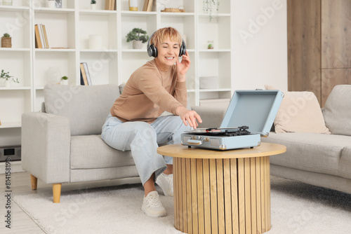 Mature woman in headphones ...