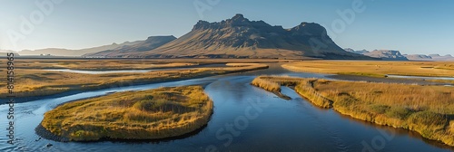 Aerial view of a river estuary crossing the valley with mountain in background, Kirkjubaejarklaustur, Southern Region, Iceland realistic nature and landscape photo