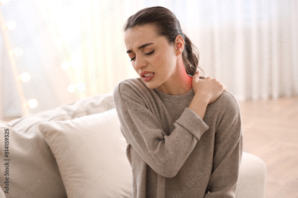 Woman suffering from neck pain at home Woman suffering from neck pain at home