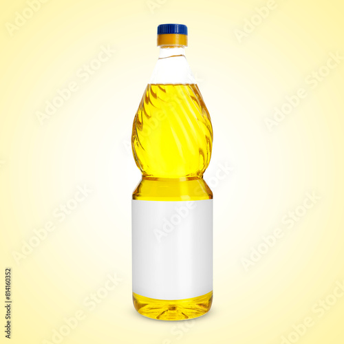 Cooking oil in plastic bottle with empty label on light yellow background. Mockup for design photo