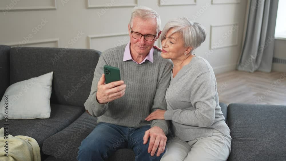 Video call. Happy senior couple woman man with smartphone having video call. Mature old grandmother grandfather talking speaking online. Older generation modern tech usage. Virtual meeting online chat Video call. Happy senior couple woman man with smartphone having video call. Mature old grandmother grandfather talking speaking online. Older generation modern tech usage. Virtual meeting online chat