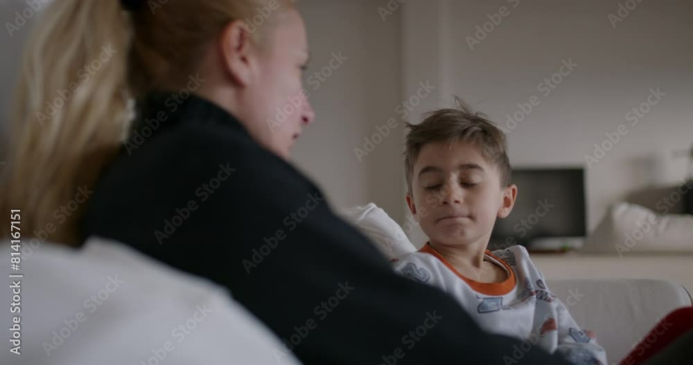 A mother is seen berating her young son, who appears attentive and possibly remorseful, in the familiar environment of their home. A mother is seen berating her young son, who appears attentive and possibly remorseful, in the familiar environment of their home.