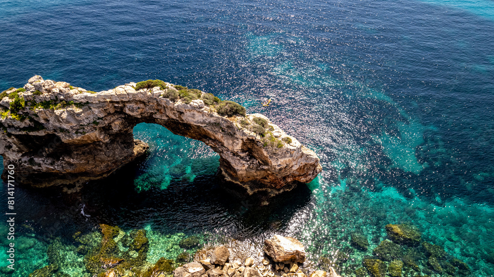 The coast of Cala D'or in South of Mallorca Spain in summer time on a sunny day with blue water and rocks The coast of Cala D'or in South of Mallorca Spain in summer time on a sunny day with blue water and rocks