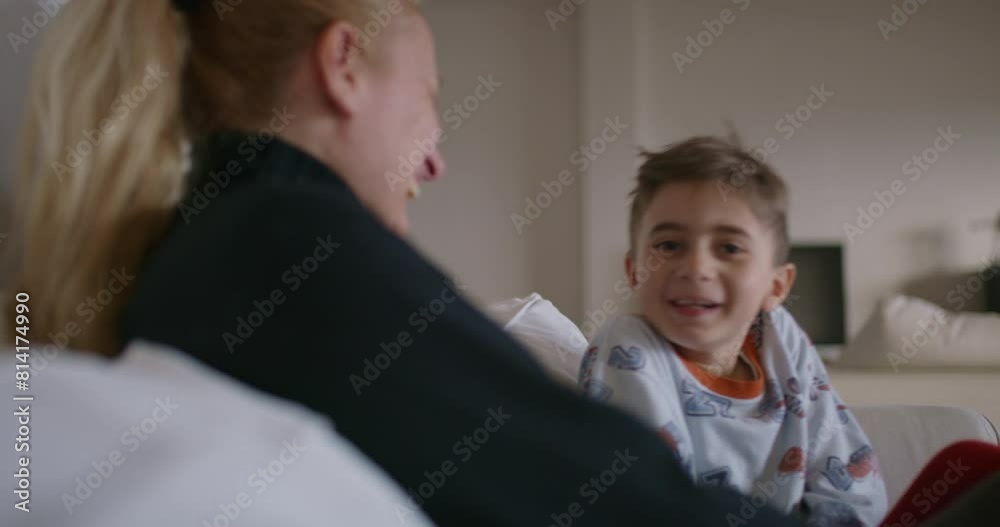 A mother is seen reprimanding her young son, who appears attentive and possibly remorseful, in the familiar environment of their home. A mother is seen reprimanding her young son, who appears attentive and possibly remorseful, in the familiar environment of their home.