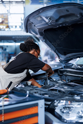 Photography Car service technician expertly examines engine using advanced mechanical tools, ensuring flawless automotive performance and safety