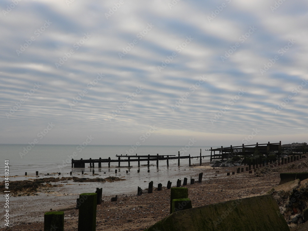 Fototapeta premium Evening sea beach with breakwaters