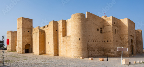Exterior view of Ribat of Monastir, historical fortress in Tunisia, showcasing sturdy medieval Islamic architecture with high walls and strategic towers .. photo