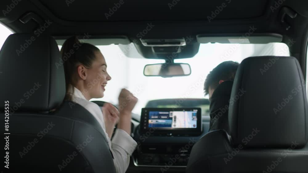 Competent car dealer using tablet for work with clients at showroom. Talking with manager while buying car at dealership center. Competent car dealer using tablet for work with clients at showroom. Talking with manager while buying car at dealership center.