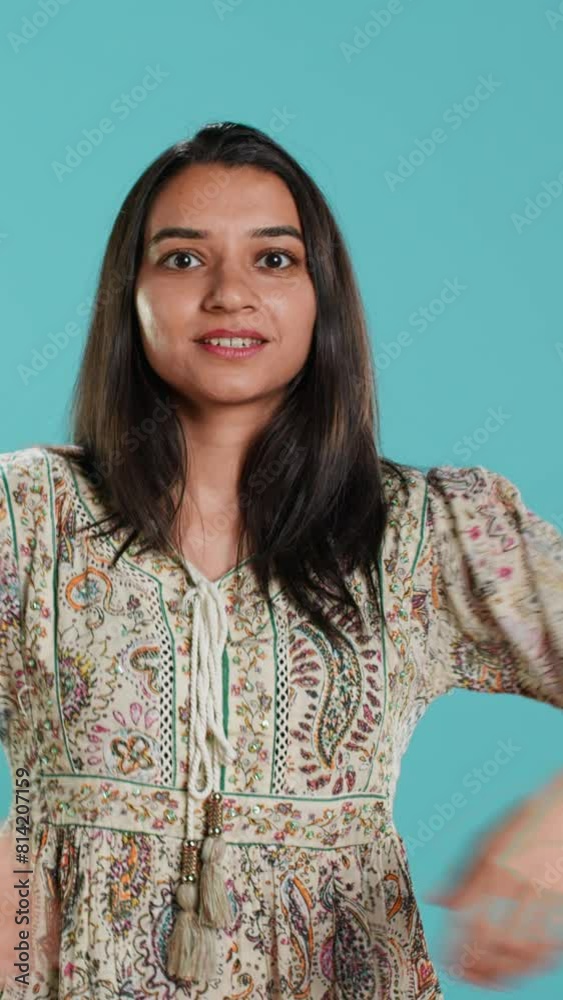 Vertical video Happy indian person having fun, dancing on rhythm, enjoying leisure time. Cheerful woman entertaining herself doing funky movements, isolated over studio background, camera A Vertical video Happy indian person having fun, dancing on rhythm, enjoying leisure time. Cheerful woman entertaining herself doing funky movements, isolated over studio background, camera A