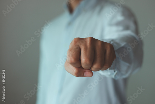 A businessman throwing the punch, Man in a suit showing anger with his right fist ready to fight.