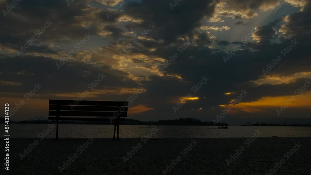 Silhouette of a bench on the embankment at sunset Silhouette of a bench on the embankment at sunset