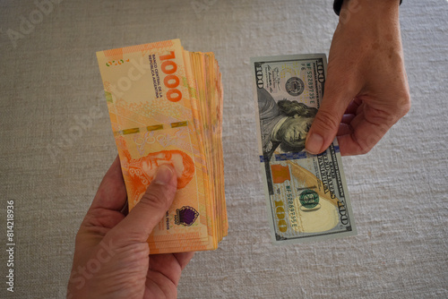 exchanging US dollars for Argentine pesos, symbol for inflation in Argentina