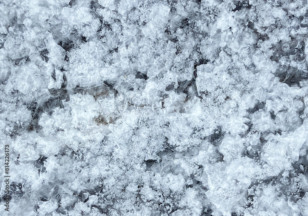 Fototapeta premium Crystals of sea salt on black volcanic lava stone of the coast of Atlantic ocean.Natural background. Tenerife,Canary Islands,Spain. Selective focus.