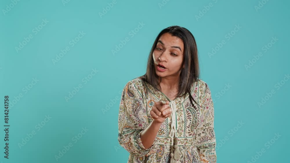 Upset indian person fighting with friend, doing scolding gesturing, isolated over studio backdrop. Annoyed woman arguing with opponent during discussion, doing admonishing hand gestures, camera A