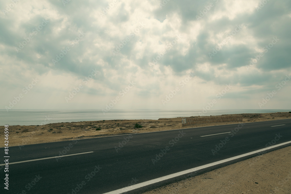 Empty rural road in the desert of Gheshm island, Iran with a cloudy sky. Empty rural road in the desert of Gheshm island, Iran with a cloudy sky.