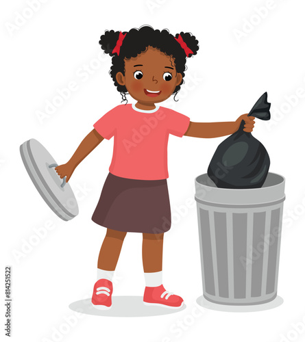 Cute little African girl taking out the trash in garbage bag into recycling bin