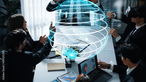 Project manager using VR glass to connect global connection with hologram of big data and digital screen flowing while team programing system while business team send data from laptop. Directorate.