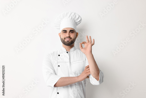 Professional chef with showing OK gesture on white background