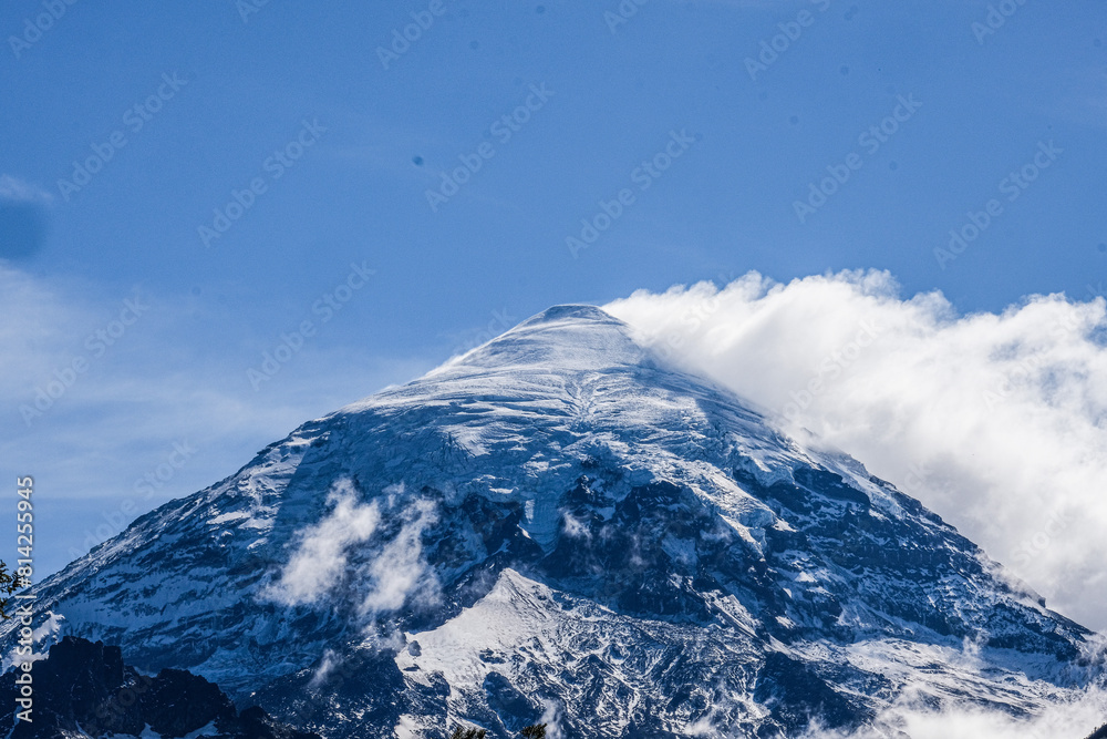 Lanin volcano surrounded by clouds, clear summit in sight and ice glaciers, between Argentina and Chile, Lanin National Park Lanin volcano surrounded by clouds, clear summit in sight and ice glaciers, between Argentina and Chile, Lanin National Park