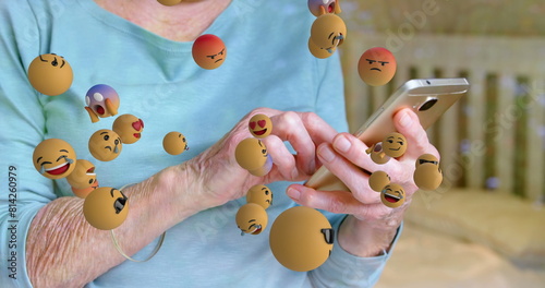 Image of emoticons floating over hands of caucasian senior woman using smartphone