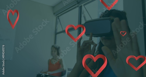 Image of falling hearts over caucasian woman using vr headset