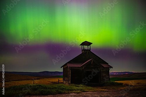 Abandoned Schoolhouse under the light of the Aurora Borealis. 