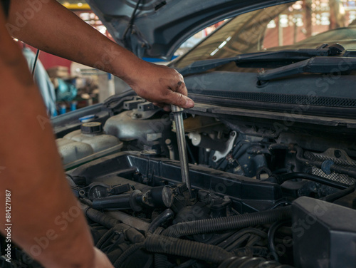 Close up Man hands fixing Car machinery vehicle mechanical service. Mechanic man hands repairing car auto repair shop. open vehicle hood checking up auto mobile. Vehicle Car maintenance engineer. © aFotostock