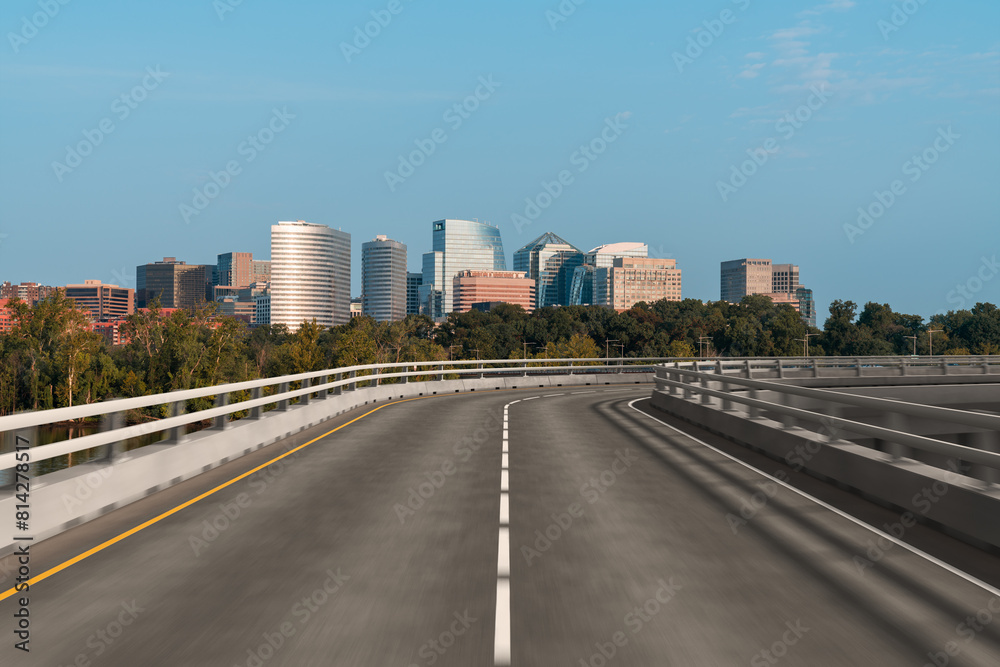 Empty urban asphalt road exterior with city buildings background. New modern highway concrete construction. Concept way to success. Transportation logistic industry fast delivery. Arlington. USA.