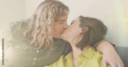 Image of light over happy caucasian female gay couple