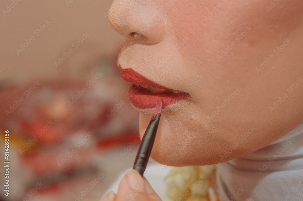 closeup of someone's lips applying lip color closeup of someone's lips applying lip color