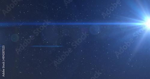 Image of blue glowing light moving over stars on blue background photo