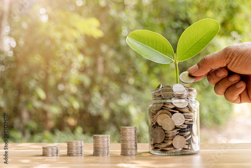 Coins in a clear glass jar money saving concept