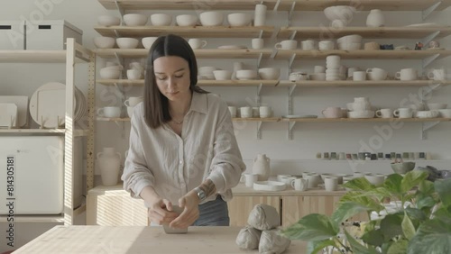 A female ceramicist kneading clay photo